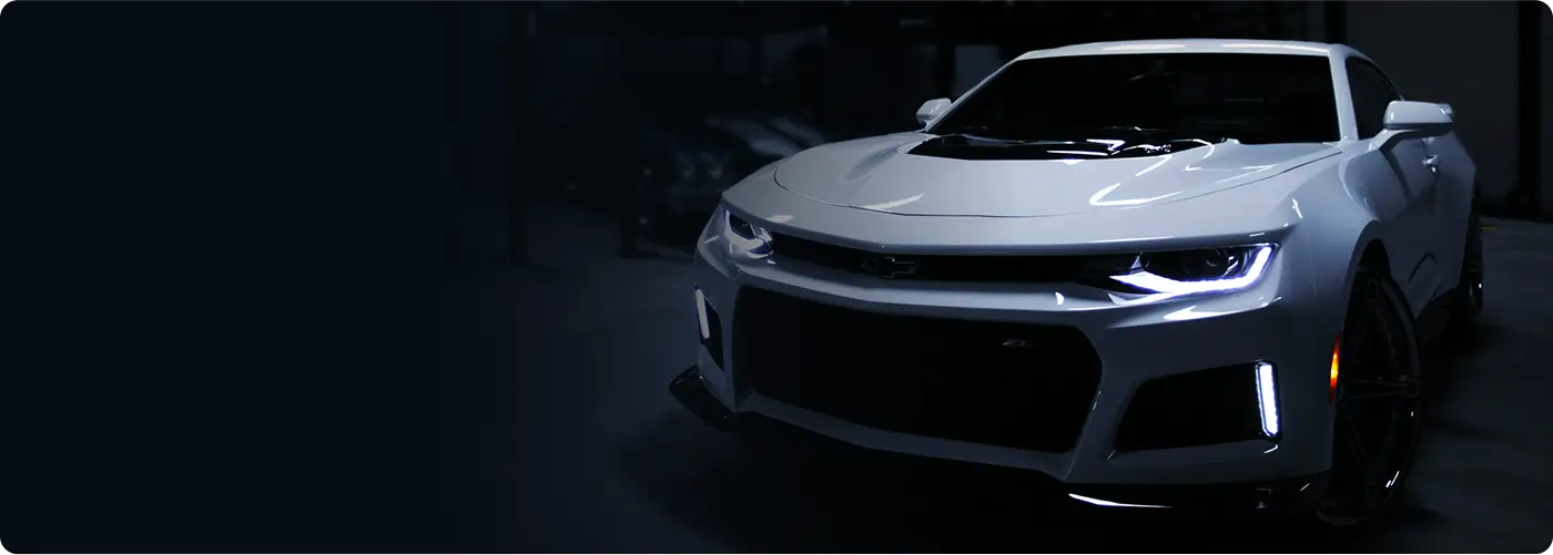 A red Lukoil racing car drifting on track with smoke effects showing dynamic motorsport action